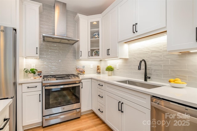 2845 Lakefront Dr, Belmont, NC 28012 - kitchen with wall chimney range hood, appliances with stainless steel finishes, a sink, light countertops, and decorative backsplash