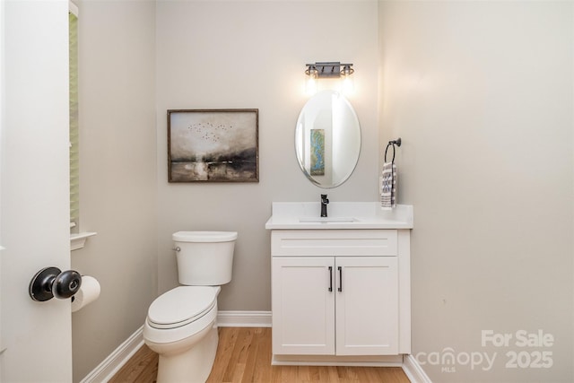 2845 Lakefront Dr, Belmont, NC 28012 - half bathroom with wood finished floors, baseboards, toilet, and vanity