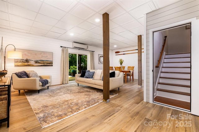 2845 Lakefront Dr, Belmont, NC 28012 - living room with a wall mounted AC, stairs, wood finished floors, recessed lighting, and wooden walls