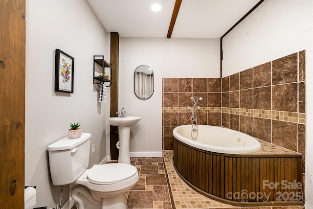 2845 Lakefront Dr, Belmont, NC 28012 - full bath with toilet, a garden tub, stone finish flooring, and baseboards