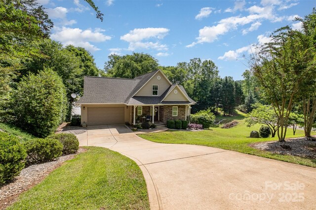 2845 Lakefront Dr, Belmont, NC 28012 - craftsman house with driveway, a front yard, an attached garage, a porch, and brick siding