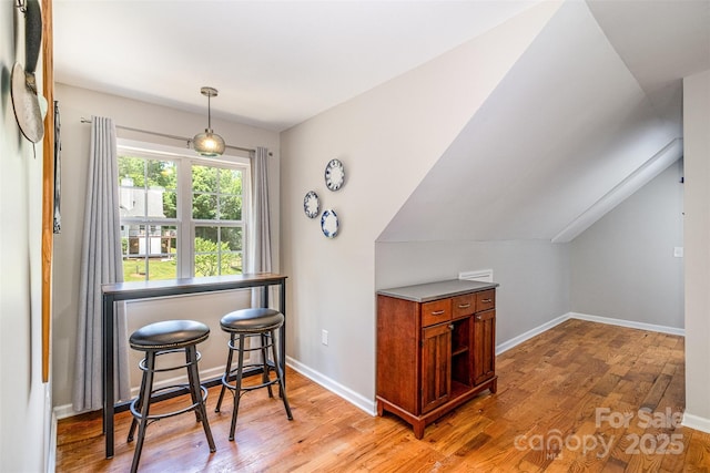 2845 Lakefront Dr, Belmont, NC 28012 - dining area featuring light wood-type flooring, baseboards, and lofted ceiling