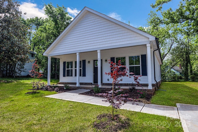 bungalow-style house with covered porch and a front yard