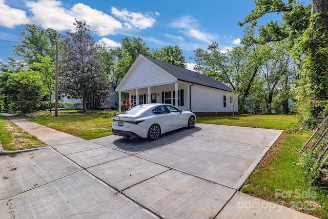 view of side of property with a lawn