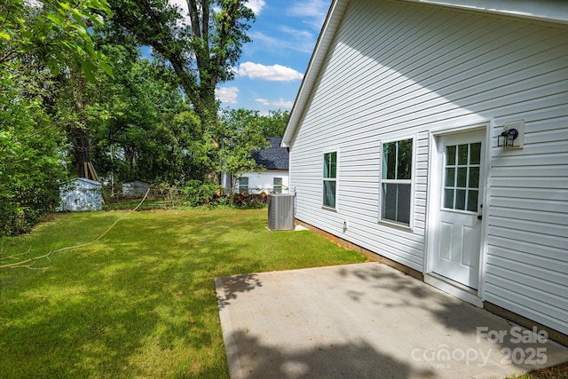 view of grassy yard with a patio area and cooling unit