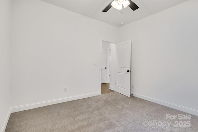unfurnished room featuring carpet, ceiling fan, and baseboards