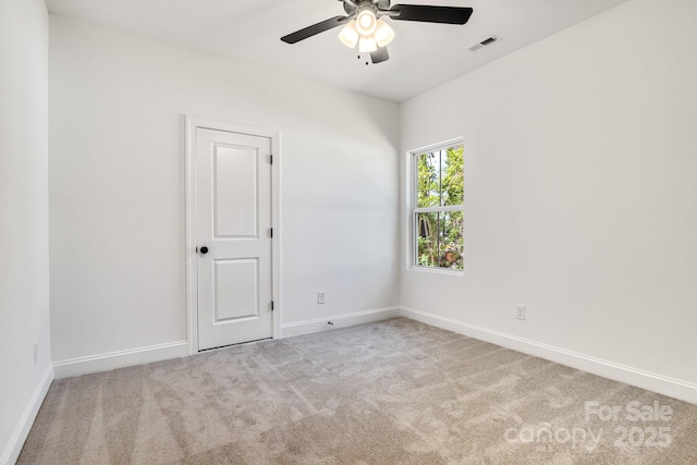 unfurnished room with carpet floors, ceiling fan, and baseboards