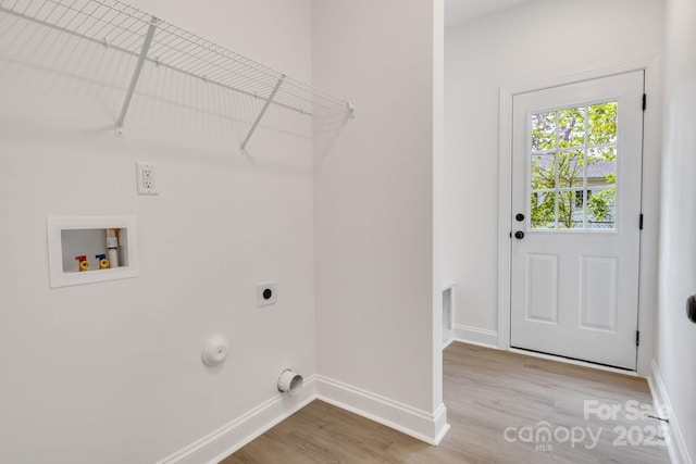 laundry room featuring wood finished floors, baseboards, hookup for a washing machine, gas dryer hookup, and hookup for an electric dryer