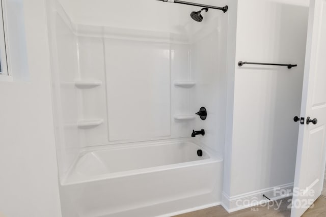 bathroom with baseboards and a shower