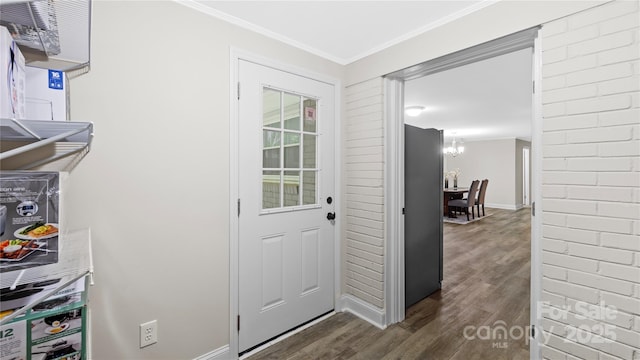 7860 Henry Harris Rd, Fort Mill, SC 29707 - entryway featuring dark wood-type flooring, crown molding, a chandelier, and baseboards