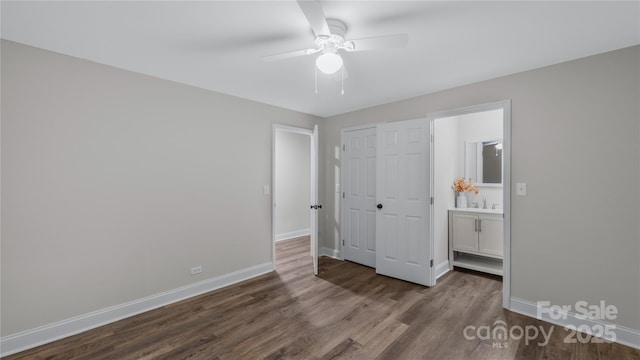 7860 Henry Harris Rd, Fort Mill, SC 29707 - unfurnished bedroom featuring dark wood-style flooring, baseboards, a sink, a closet, and ensuite bathroom