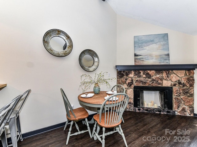100 Willow Run Dr Unit 26, Gastonia, NC 28056 - dining area with vaulted ceiling, wood finished floors, a fireplace, and baseboards