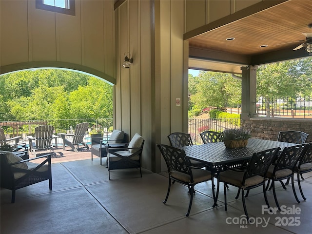 view of patio featuring fence, a ceiling fan, and outdoor dining area