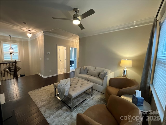 living area featuring dark wood-style flooring, ornamental molding, ceiling fan, and baseboards