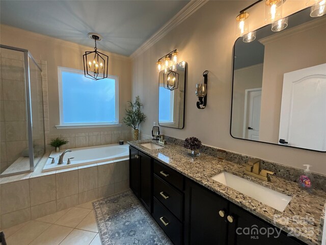 bathroom with tile patterned floors, a garden tub, a chandelier, a tile shower, and double vanity