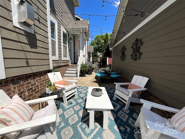 view of patio / terrace with an outdoor living space with a fire pit