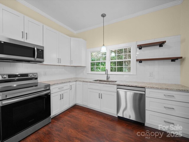 300 W 12th St, Salisbury, NC 28144 - kitchen with appliances with stainless steel finishes, a sink, crown molding, dark wood-style flooring, and white cabinetry