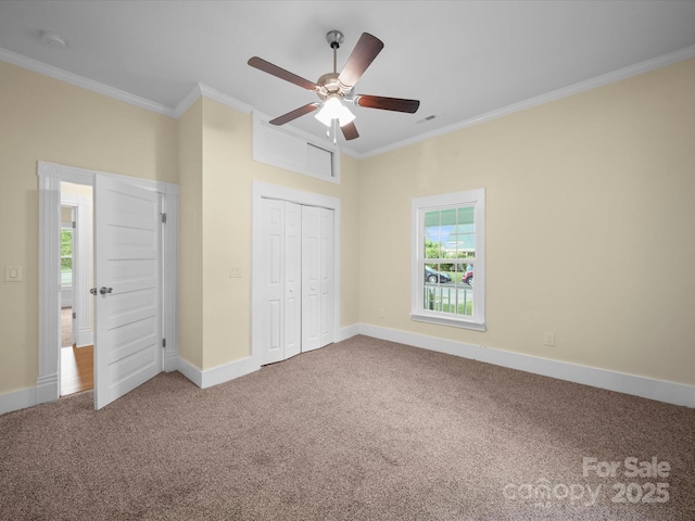 300 W 12th St, Salisbury, NC 28144 - unfurnished bedroom featuring carpet, crown molding, baseboards, a closet, and a ceiling fan