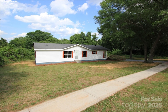 view of front of house featuring entry steps and a front lawn