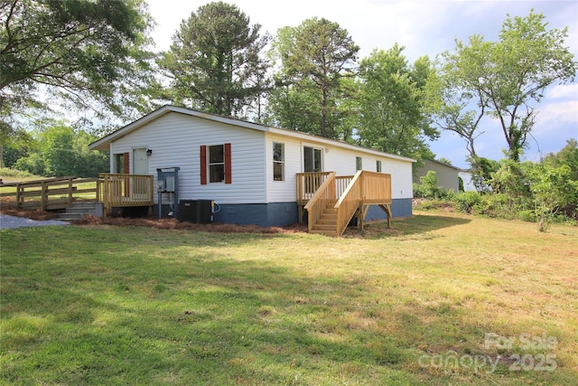 rear view of house with a deck, a lawn, crawl space, and cooling unit
