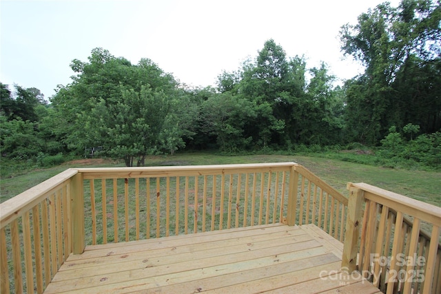 wooden terrace with a yard