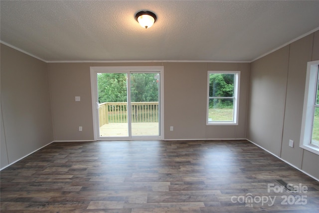 unfurnished room featuring dark wood finished floors, ornamental molding, a textured ceiling, and baseboards