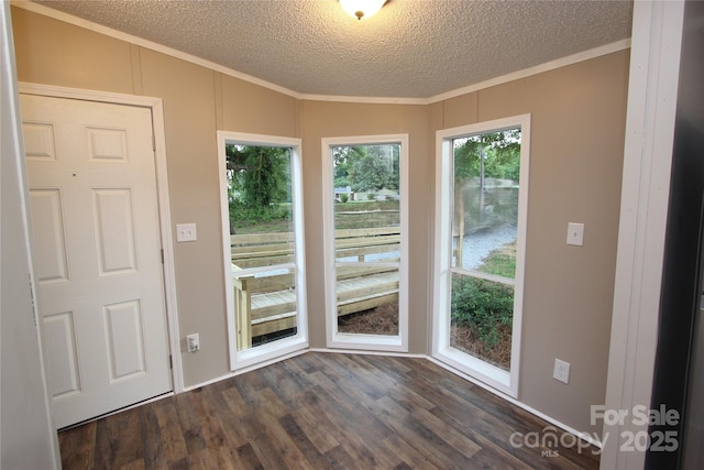 entryway with crown molding, dark wood-style flooring, and a textured ceiling