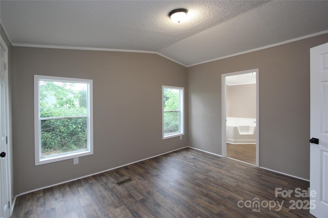 unfurnished bedroom featuring lofted ceiling, dark wood-style floors, crown molding, baseboards, and a textured ceiling