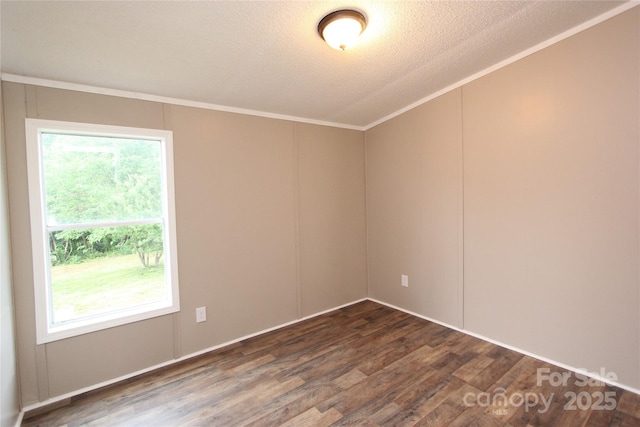 spare room with dark wood-type flooring, crown molding, and a textured ceiling