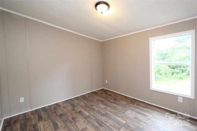 empty room featuring wood finished floors, ornamental molding, and a textured ceiling
