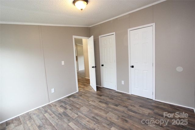 unfurnished bedroom featuring wood finished floors, crown molding, and a textured ceiling