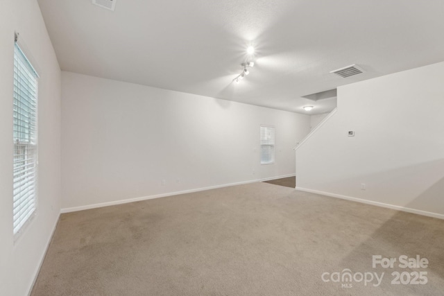1835 Allegheny Dr, Gastonia, NC 28054 - basement featuring healthy amount of natural light, baseboards, carpet flooring, and track lighting