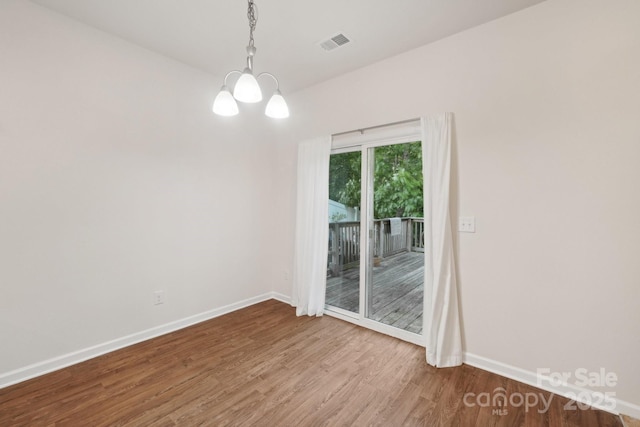 1835 Allegheny Dr, Gastonia, NC 28054 - spare room with wood finished floors, baseboards, and a chandelier