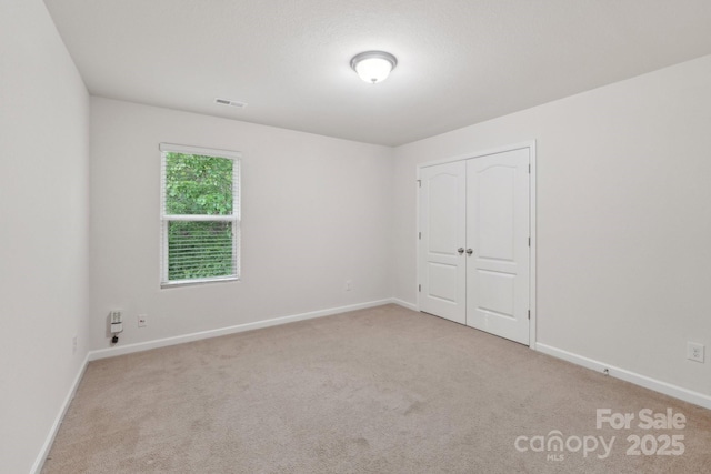 1835 Allegheny Dr, Gastonia, NC 28054 - unfurnished bedroom featuring carpet flooring, baseboards, and a closet