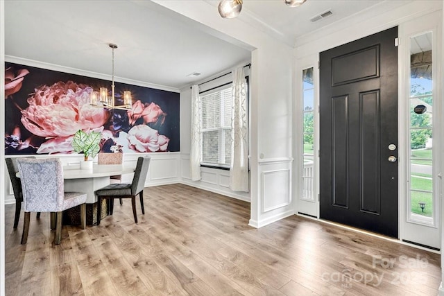 862 Kathy Dianne Dr, Fort Mill, SC 29707 - entrance foyer featuring ornamental molding, a chandelier, a decorative wall, wood finished floors, and a wainscoted wall