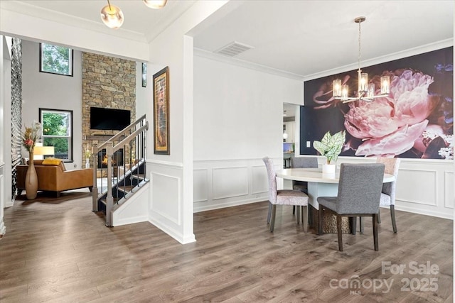 862 Kathy Dianne Dr, Fort Mill, SC 29707 - dining room with a chandelier, crown molding, wood finished floors, a wainscoted wall, and a decorative wall