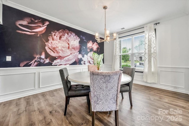 862 Kathy Dianne Dr, Fort Mill, SC 29707 - dining space featuring a chandelier, a decorative wall, ornamental molding, wainscoting, and wood finished floors