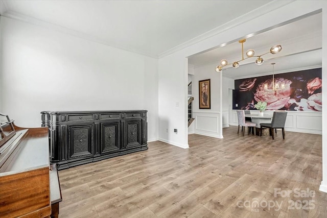 862 Kathy Dianne Dr, Fort Mill, SC 29707 - living room featuring a chandelier, crown molding, a decorative wall, light wood finished floors, and a wainscoted wall