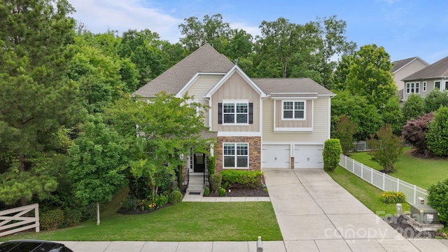 1104 Snowbird Ln, Waxhaw, NC 28173 - craftsman-style house with board and batten siding, a garage, stone siding, and driveway
