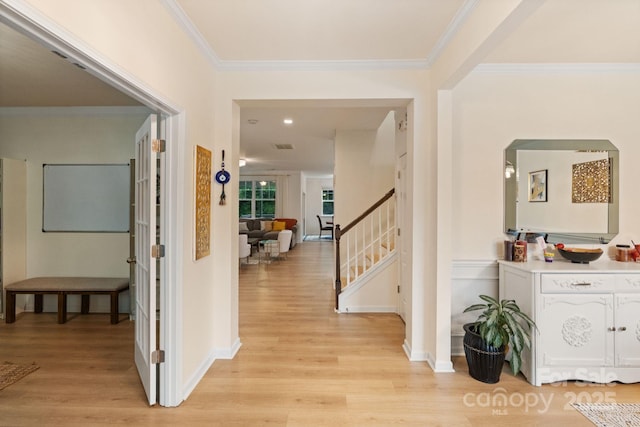 1104 Snowbird Ln, Waxhaw, NC 28173 - hall with stairs, light wood-style flooring, ornamental molding, arched walkways, and baseboards