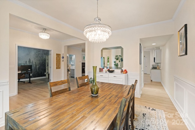 1104 Snowbird Ln, Waxhaw, NC 28173 - dining space with light wood-style floors, ornamental molding, and a chandelier