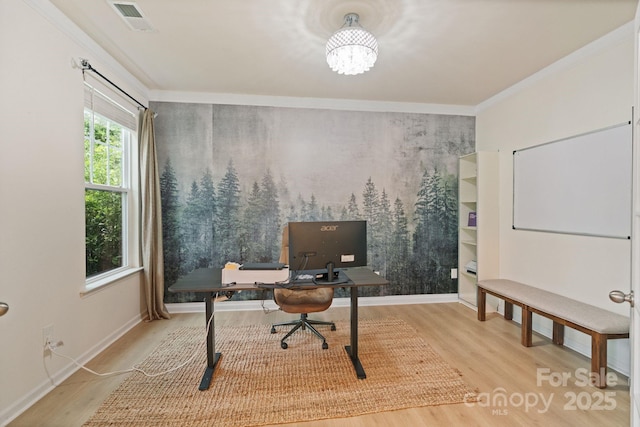 1104 Snowbird Ln, Waxhaw, NC 28173 - office area featuring wood finished floors, an accent wall, crown molding, a chandelier, and baseboards