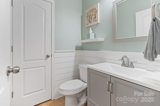 1104 Snowbird Ln, Waxhaw, NC 28173 - bathroom featuring vanity, toilet, wood finished floors, and a wainscoted wall