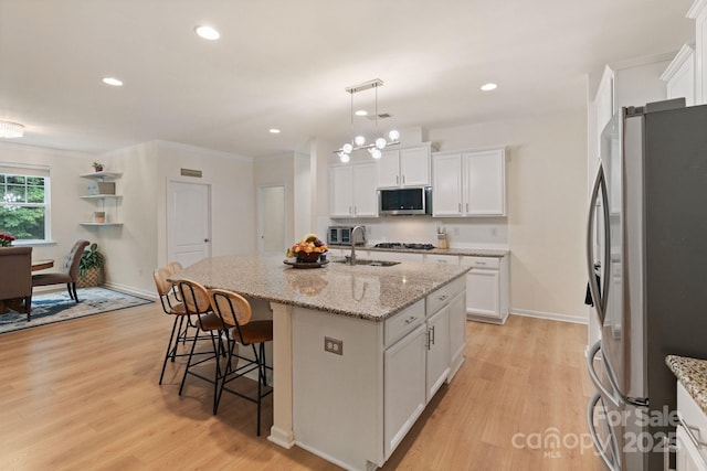 1104 Snowbird Ln, Waxhaw, NC 28173 - kitchen featuring stainless steel appliances, light wood finished floors, white cabinets, and recessed lighting