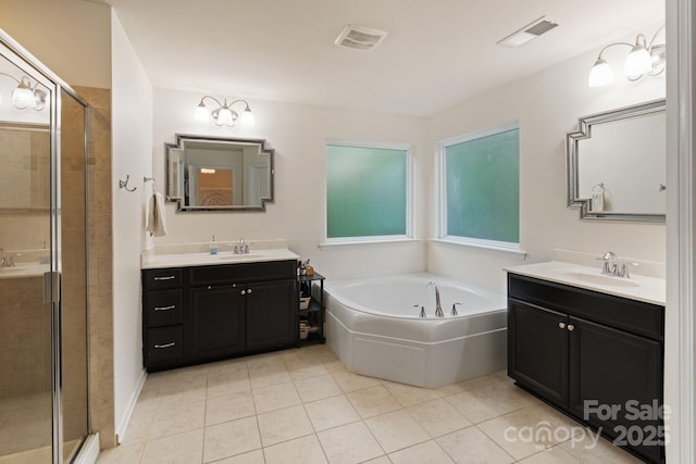 1104 Snowbird Ln, Waxhaw, NC 28173 - bathroom featuring two vanities, a stall shower, and tile patterned floors