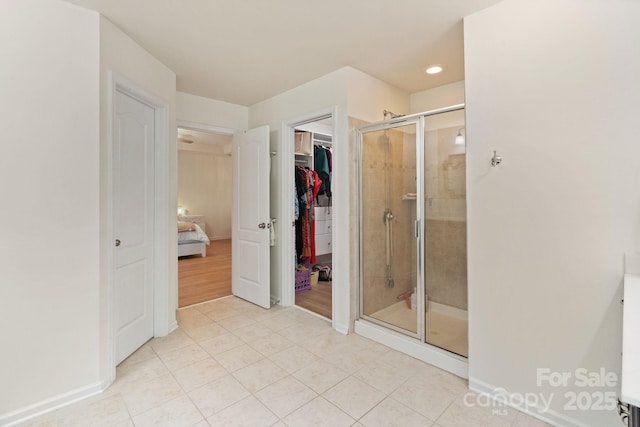 1104 Snowbird Ln, Waxhaw, NC 28173 - full bathroom with a shower stall, tile patterned flooring, a walk in closet, baseboards, and recessed lighting