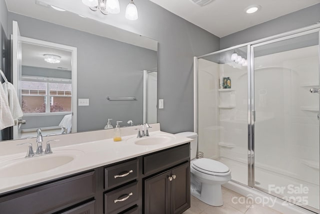 1104 Snowbird Ln, Waxhaw, NC 28173 - ensuite bathroom featuring tile patterned flooring, a stall shower, toilet, and double vanity