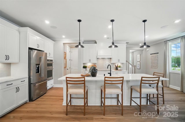12055 Lavinia Ln, Charlotte, NC 28277 - kitchen featuring appliances with stainless steel finishes, crown molding, backsplash, white cabinets, and a kitchen bar