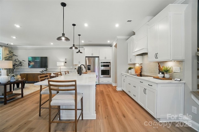 12055 Lavinia Ln, Charlotte, NC 28277 - kitchen featuring ornamental molding, appliances with stainless steel finishes, backsplash, white cabinets, and a kitchen bar