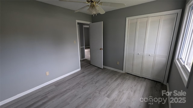 824 S Laurel St, Lincolnton, NC 28092 - unfurnished bedroom featuring wood finished floors, baseboards, a closet, and a ceiling fan